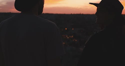 A Couple Enjoying View At Sunset