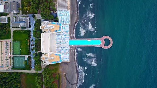 Drone Footage of a Long Swimming Pool on the Seashore