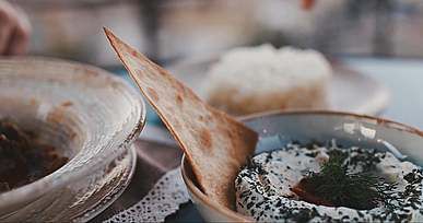 a person dipping a tortilla chip