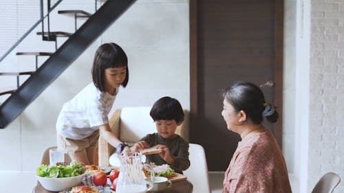 Grandmother and Her Grandchildren Making Sandwiches