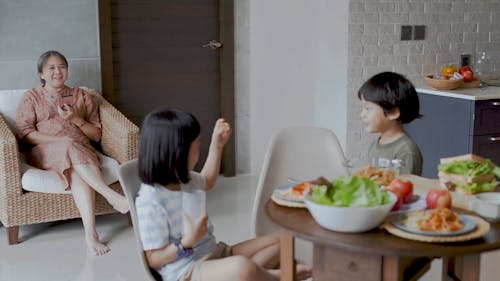 Grandson Giving Food to Her Grandmother