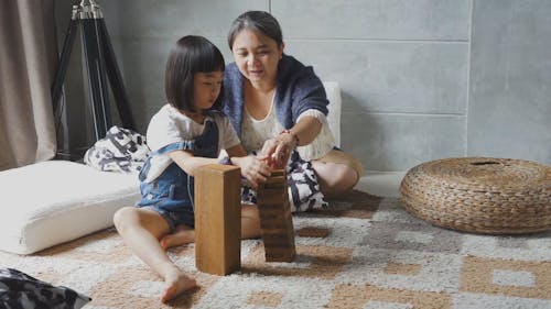 Mother and Daughter Playing Jenga