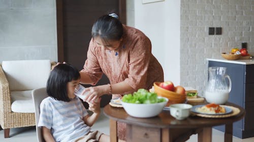 Person Taking Care of Her Daughter