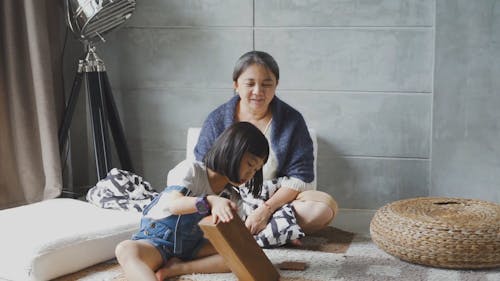 A Girl Playing with Her Mother