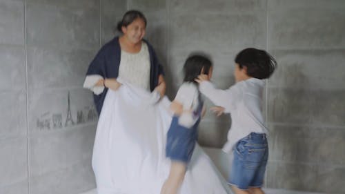 Children Jumping on the Bed