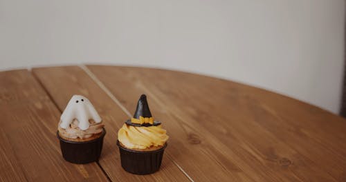 Placing Halloween Themed Cupcakes Above A Table