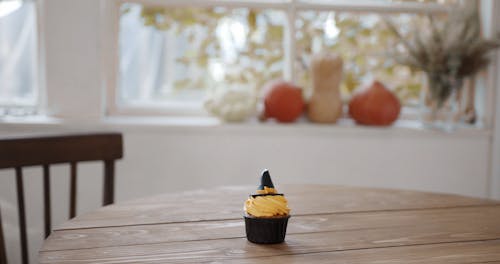Placing Halloween Cupcakes Over The Table