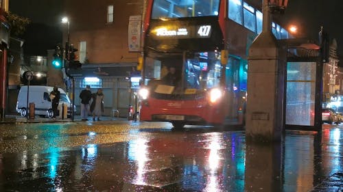 Red Bus in a Rainy City 