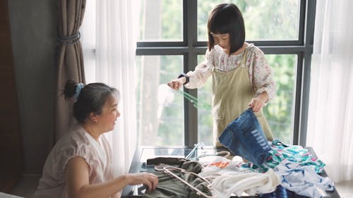 Kid Putting Clothes on a Hanger