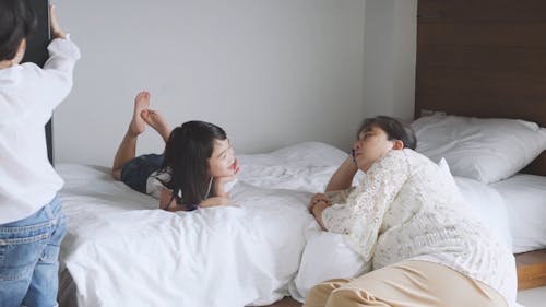 Girl Talking to a Woman on the Bed 