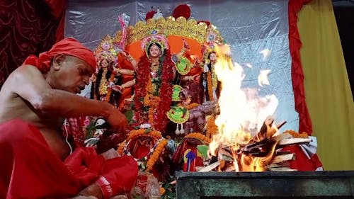 An Indian Man is Burning Leaves While Saying a Ritual to Goddess Durga