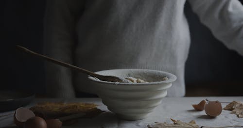 Person Pouring Milk in a Bowl