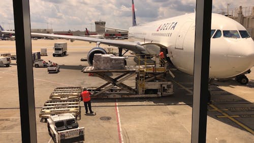 People Unloading the Cargo on the Airplane