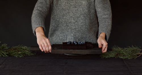 Placing Chocolate and Blueberry Cake on Wooden Table