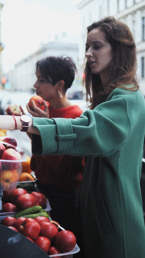 Young Couple Choosing Fruit from Street Stand