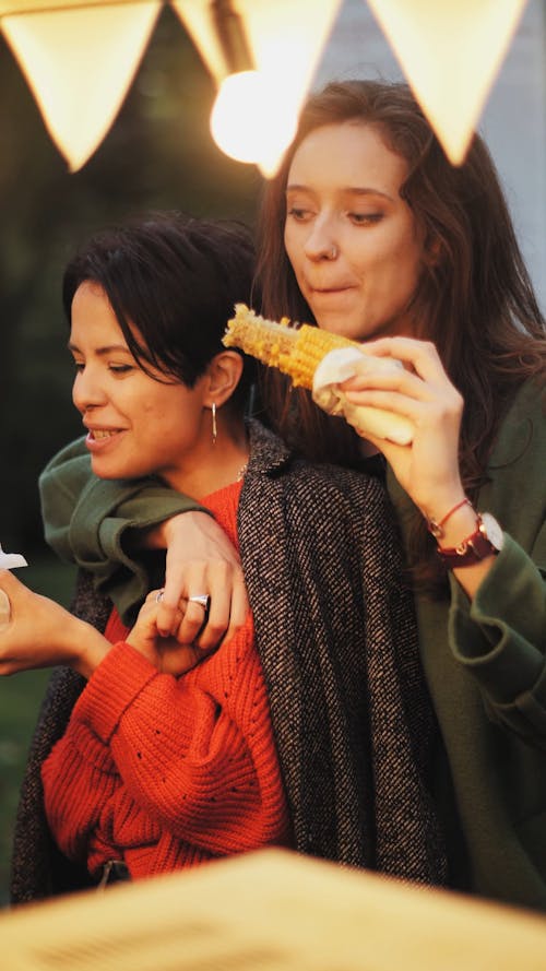 Women Couple Eating Corn