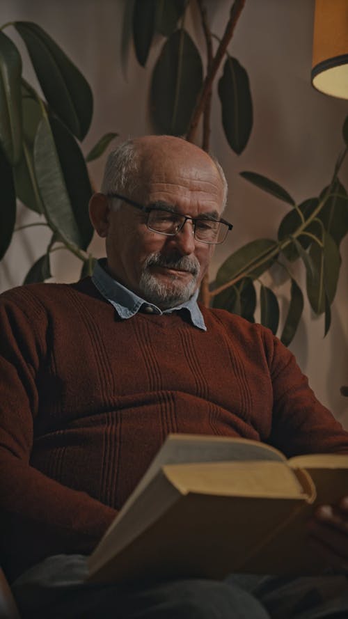 Man Wearing Eye Glasses Reading a Book