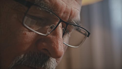 Close Up View of an Old Man Reading Book