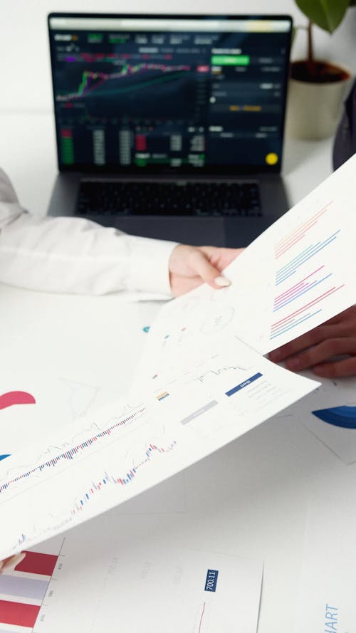 Woman Hand Over Stock Reports to a Man