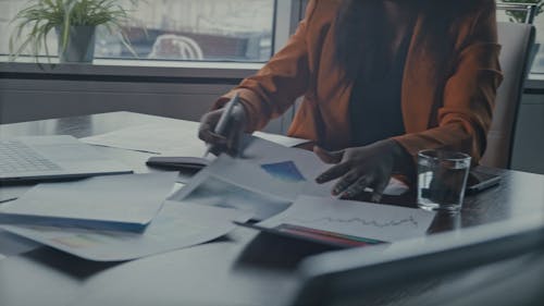 A Woman Reviewing Documents At Work