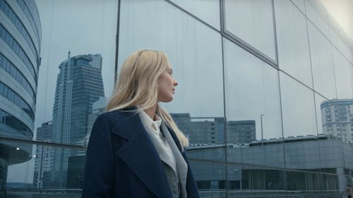 A Woman Standing Outside Of A Building