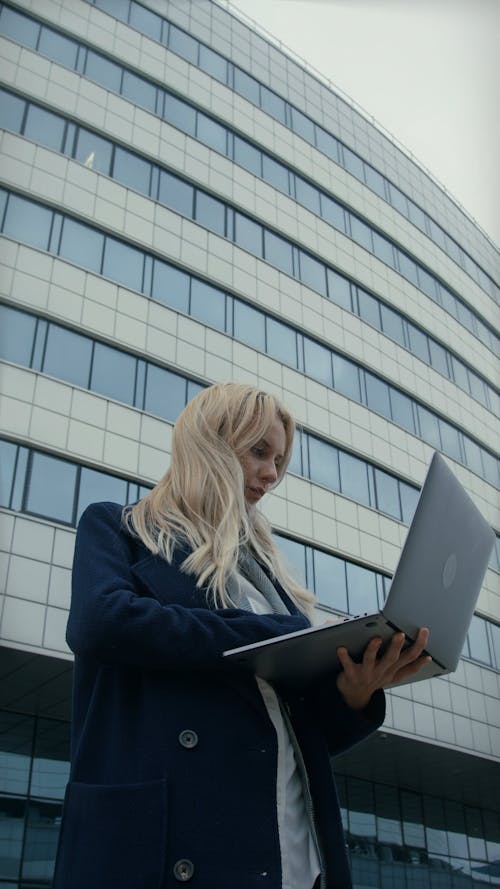 A Woman Using A Laptop Outdoors