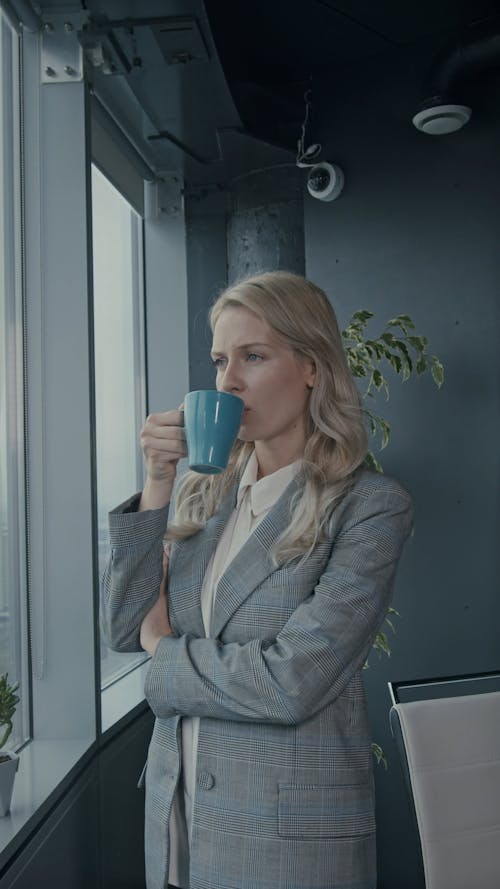 A Female Boss Drinking Coffee At Work