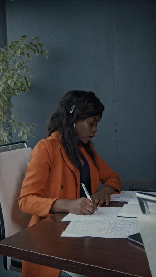A Woman Working Hard Behind Her Desk