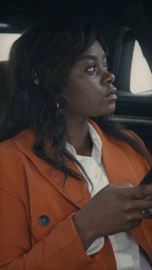 A Woman Sitting At The Back Of A Car