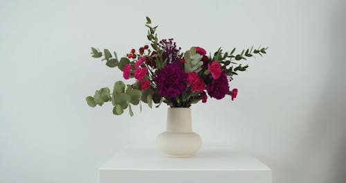 Person Rearranging a Flowering Pot