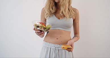 a woman making a choice of what food to eat