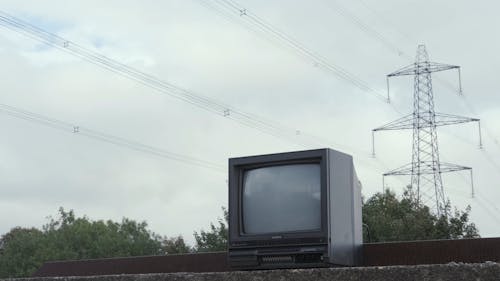 Small vintage TV set on stone fence