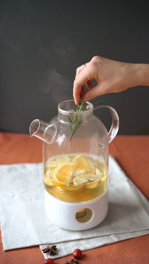 Adding Rosemary in a Jar of Tea 
