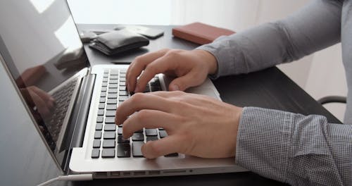 Man Typing in a Computer 