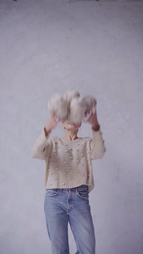 Young Woman Playing with Balls of Yarn 