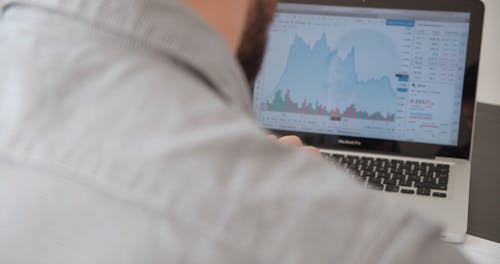 Businessman Reviewing a Graph on a Laptop