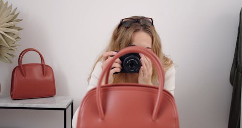 Woman Taking Pictures of Handbag for Her Online Store