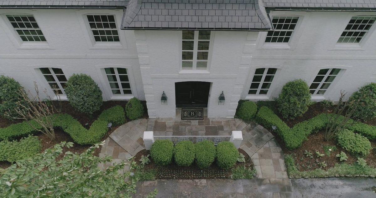 Aerial view of a luxury mansion with private pool