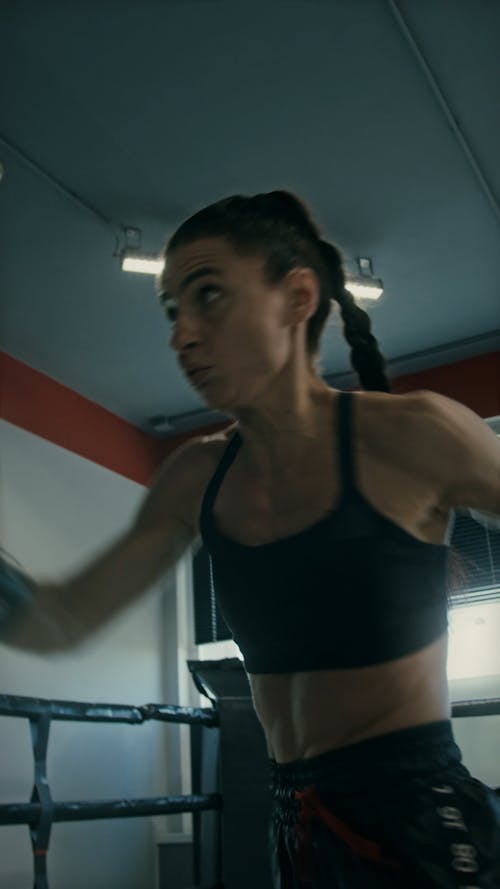 A Female Athlete Practicing Kick Boxing with a Coach