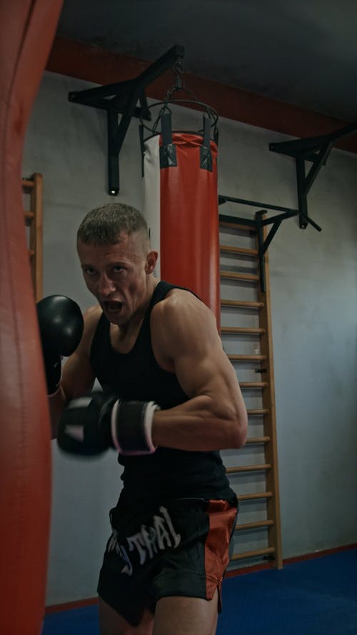 Male Boxer Practicing on Punching Bag