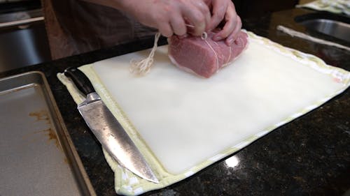Chef Tying Up a Meat 