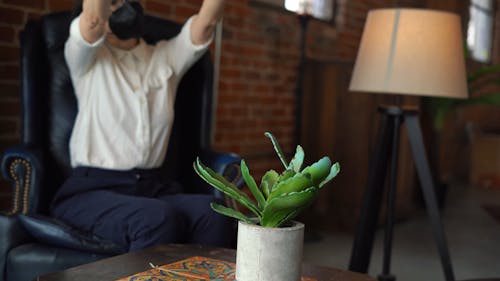 Woman Wearing Face mask Using Her Phone Finding Angle to Take a Photo