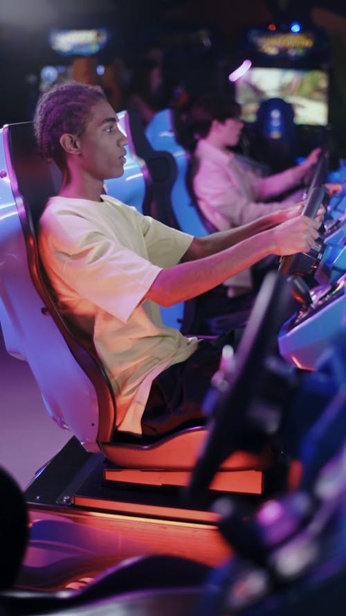 A Teenager Playing at an Amusement Arcade