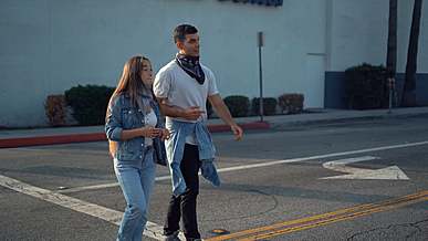 couple walking in the street and stoping by a food truck
