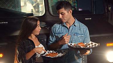 couple sharing a hot dog