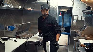 chef making hot dogs