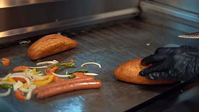 prepating hot dogs in a grill