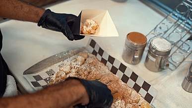 putting donuts in a takeout container