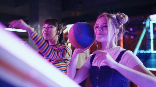 Girls Playing Basket in a Gaming Machine