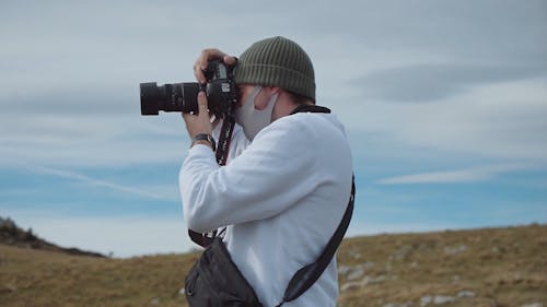 Man Clicking Pictures on Mountains